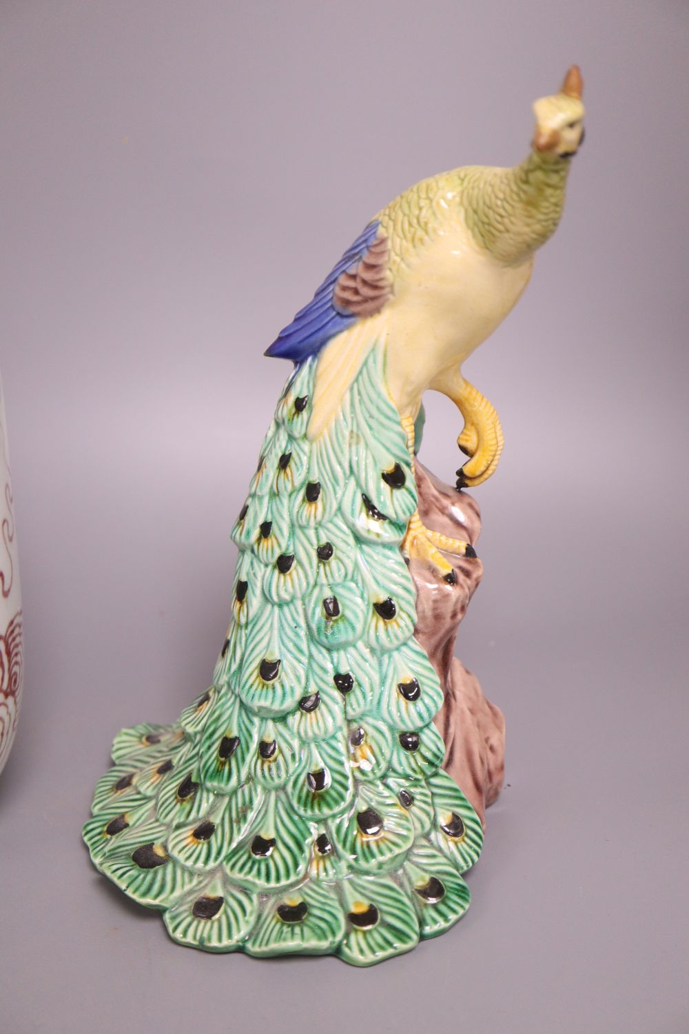 A Chinese famille verte bottle vase, an underglazed copper rouleau vase and a peacock, tallest 38cm